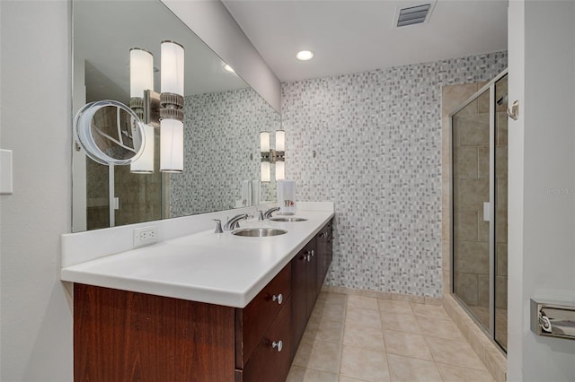 bathroom featuring tile patterned floors, vanity, and walk in shower