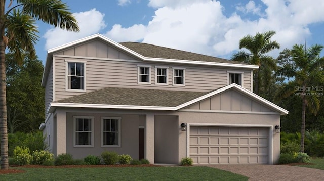 view of front of property with a front yard and a garage