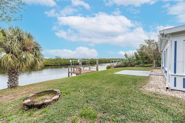 view of yard featuring a boat dock and a water view