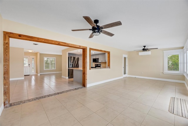 interior space with ceiling fan and light tile patterned flooring