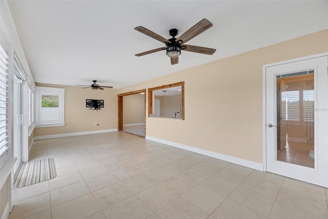 tiled spare room featuring ceiling fan and sink