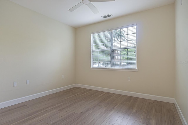 empty room featuring light hardwood / wood-style flooring and ceiling fan