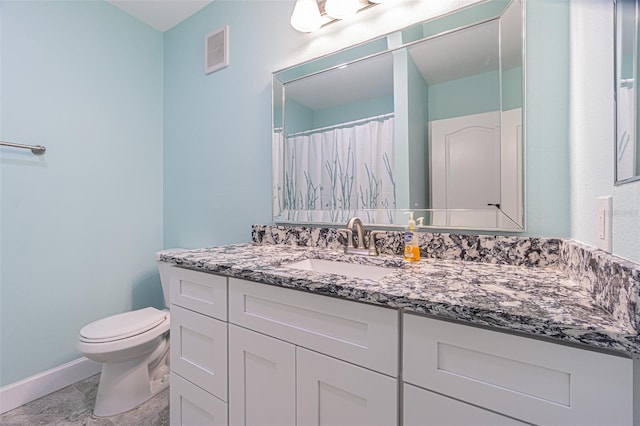 bathroom featuring vanity, toilet, and walk in shower