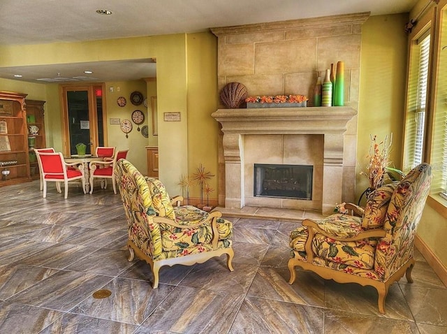 living area with a tiled fireplace