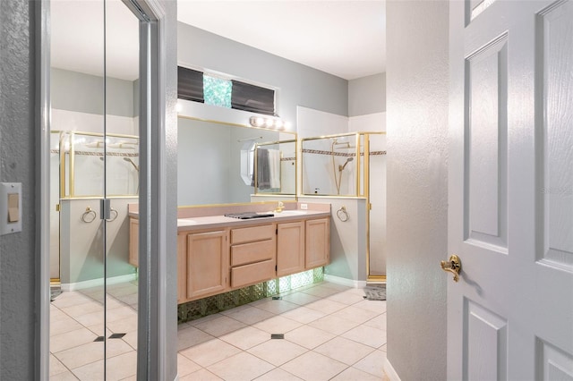 bathroom with tile patterned floors, vanity, and tiled shower