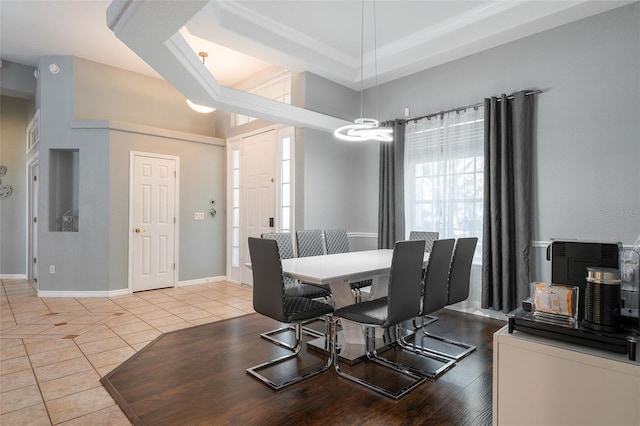 dining room featuring light tile patterned flooring and a high ceiling