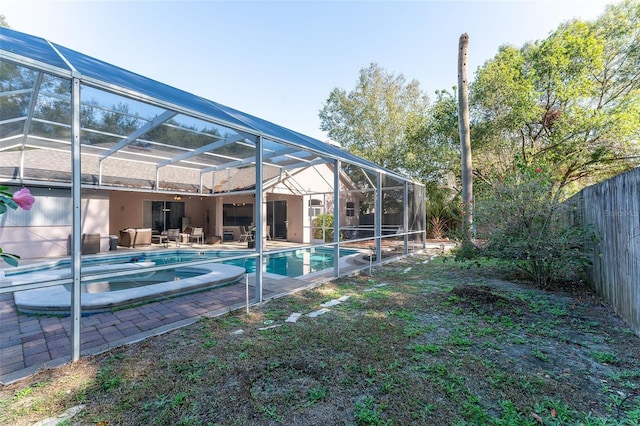 view of swimming pool featuring glass enclosure and a patio area