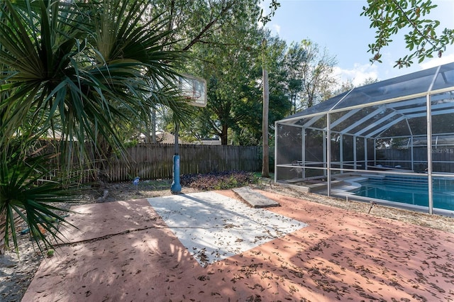 exterior space with a fenced in pool and a lanai