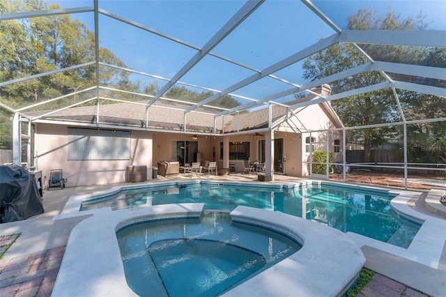 view of swimming pool with ceiling fan, a lanai, an in ground hot tub, and a patio