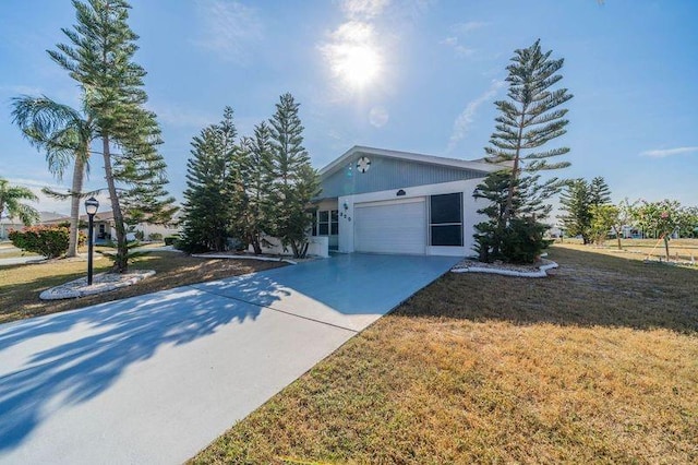 view of front of house with a front yard and a garage