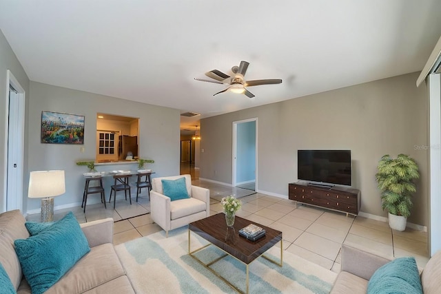 tiled living room featuring ceiling fan