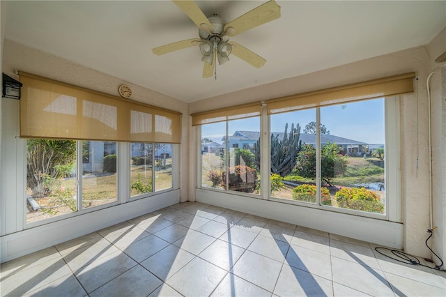 unfurnished sunroom featuring ceiling fan