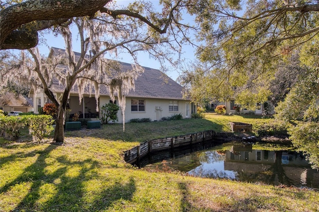 rear view of property featuring a yard