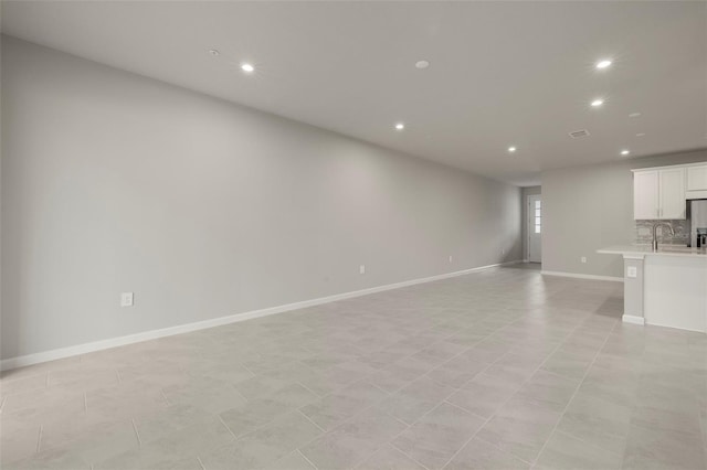 unfurnished living room featuring light tile patterned floors