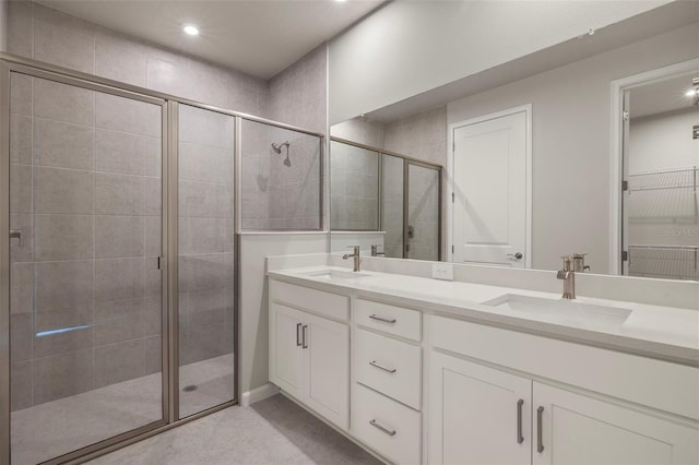 bathroom featuring vanity and a shower with shower door