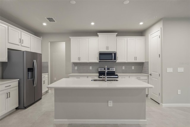 kitchen with white cabinetry, appliances with stainless steel finishes, and an island with sink