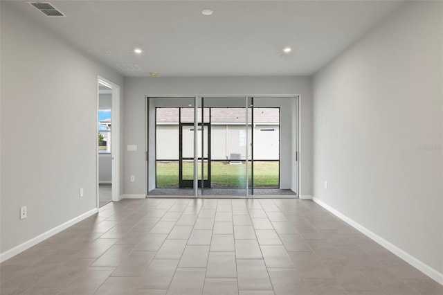 spare room featuring light tile patterned flooring