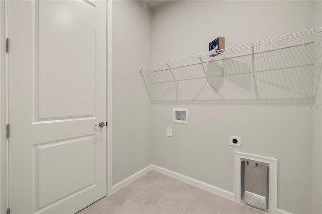 washroom with hookup for an electric dryer, hookup for a washing machine, and light tile patterned floors