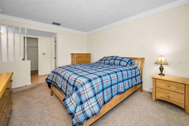 bedroom with crown molding, a closet, and a textured ceiling