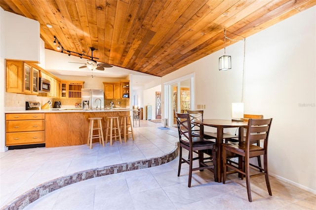 dining room with light tile patterned floors, ceiling fan, wooden ceiling, and sink