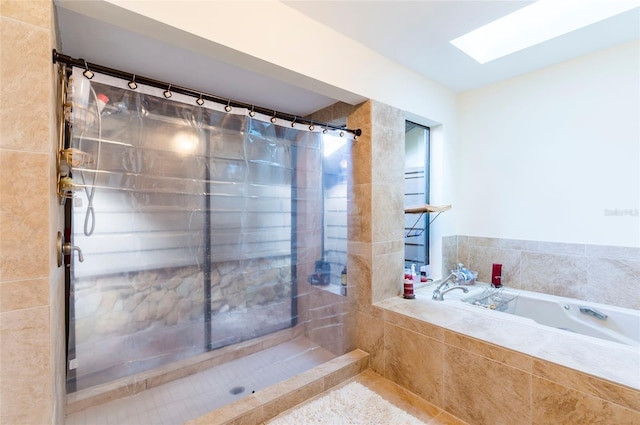 bathroom with tile patterned floors, a skylight, and independent shower and bath