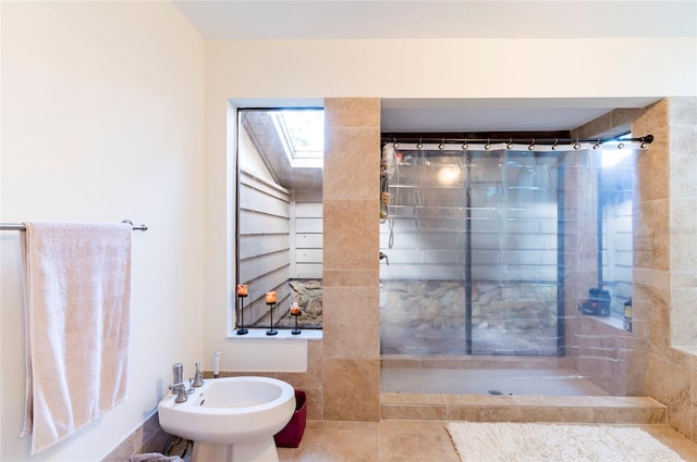 bathroom with tile patterned floors, curtained shower, and a bidet