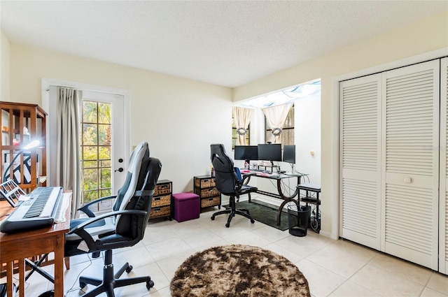 home office featuring a textured ceiling and light tile patterned flooring