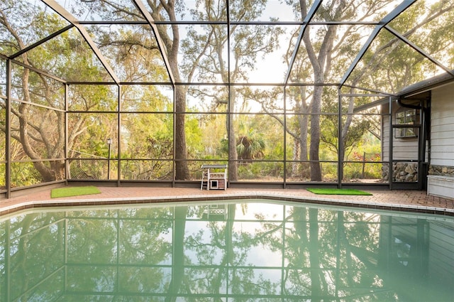 view of pool featuring glass enclosure