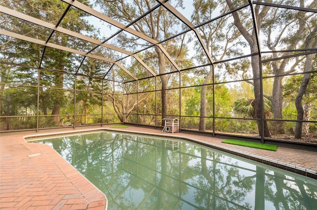 view of swimming pool with a lanai and a patio