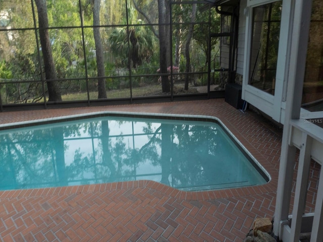 outdoor pool featuring a lanai and a patio