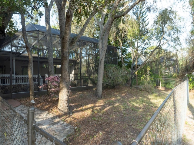 view of yard featuring a lanai and a fenced backyard