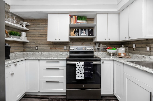 kitchen with stainless steel range with electric stovetop, white cabinetry, dark hardwood / wood-style flooring, and light stone counters