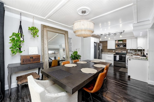 dining area with dark wood-type flooring and a chandelier