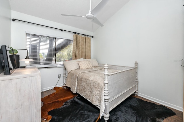 bedroom with ceiling fan, wood-type flooring, and lofted ceiling