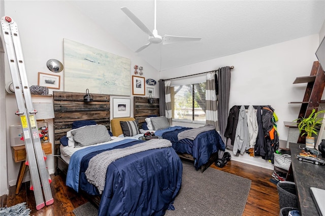 bedroom featuring ceiling fan, dark wood-type flooring, a textured ceiling, and lofted ceiling