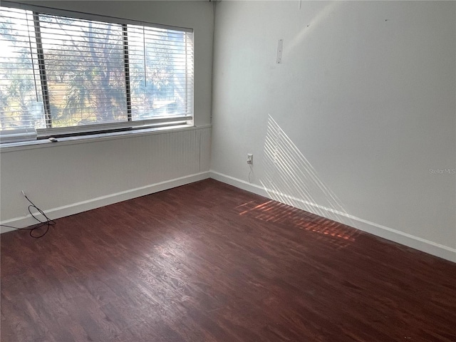 empty room with dark wood-type flooring