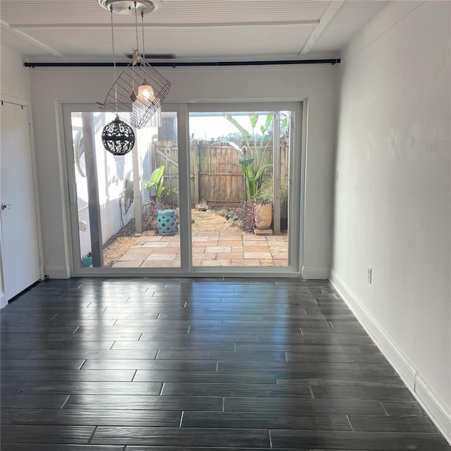 unfurnished dining area featuring dark hardwood / wood-style flooring