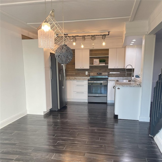 kitchen with appliances with stainless steel finishes, white cabinets, hanging light fixtures, and sink