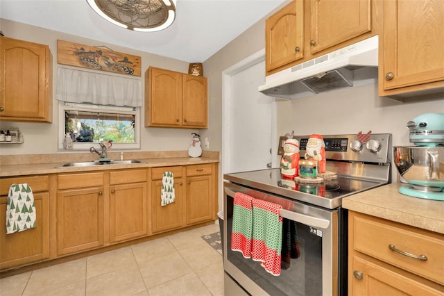 kitchen with stainless steel electric range, light tile patterned floors, and sink