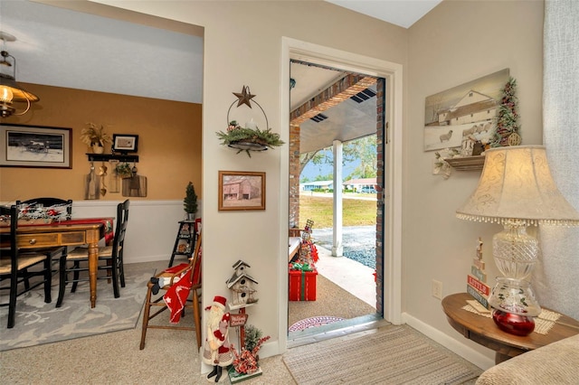 view of carpeted foyer entrance