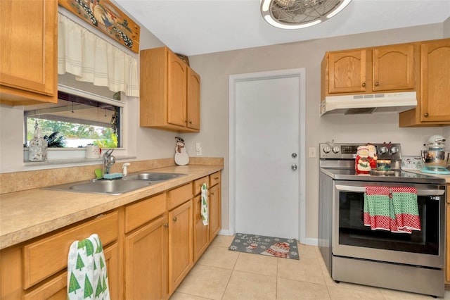 kitchen with sink, light tile patterned floors, and stainless steel range with electric cooktop