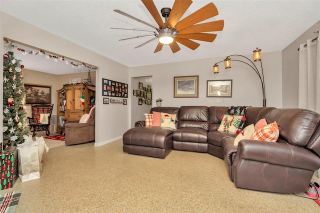 living room with a textured ceiling and ceiling fan