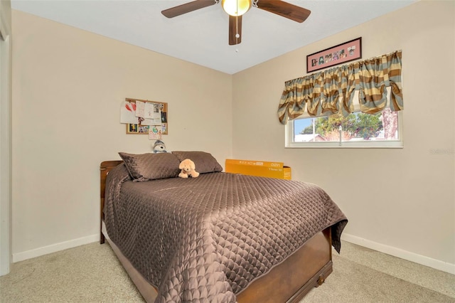 bedroom featuring light colored carpet and ceiling fan