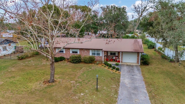 single story home with a garage and a front lawn