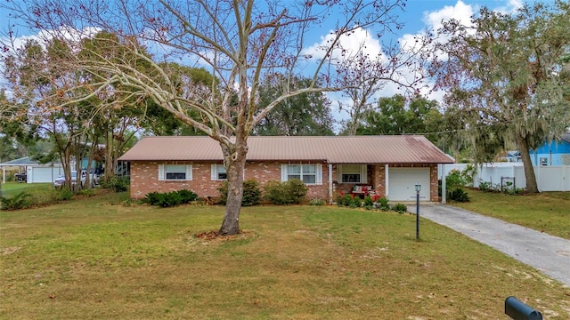 ranch-style house with a front yard and a garage