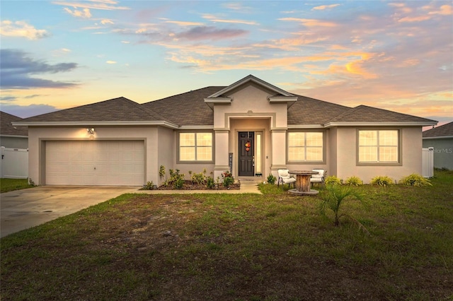 view of front of home featuring a lawn and a garage