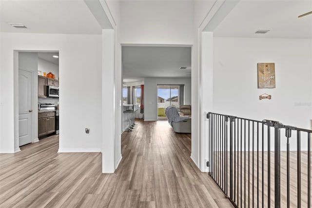 hallway with light hardwood / wood-style flooring