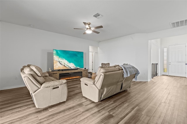 living room with hardwood / wood-style floors and ceiling fan