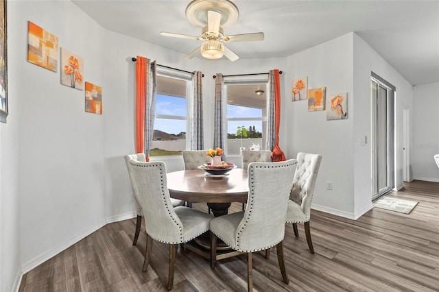 dining space with wood-type flooring and ceiling fan