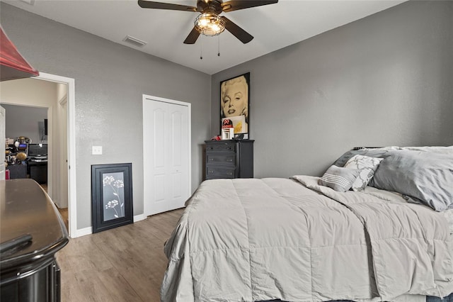 bedroom featuring wood-type flooring and ceiling fan